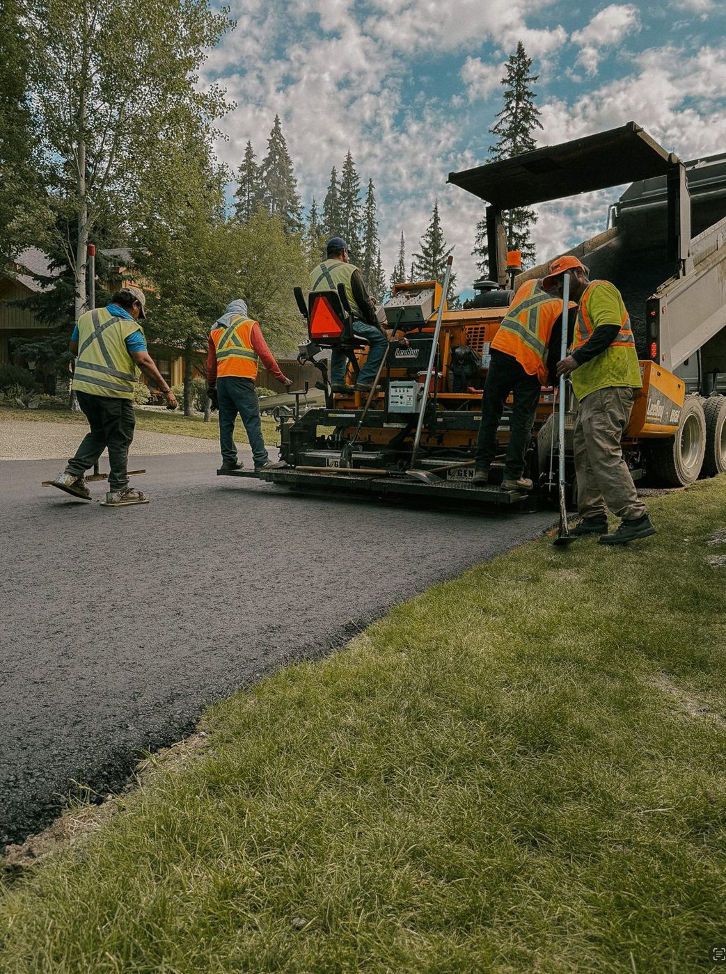Crew laying a new asphalt driveway