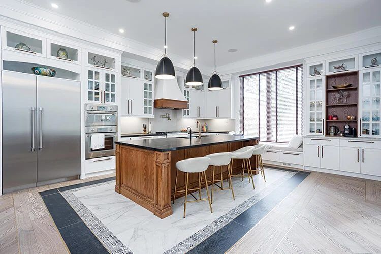 Renovated kitchen with island and white cabinetry